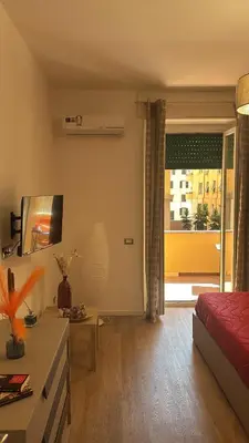a living room with a red bed and a table at Imera House City Retreat in Rome