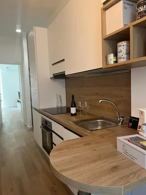 a kitchen with a sink and a counter with wine glasses at Imera House City Retreat in Rome