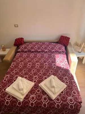 a bed with two pillows on it in a room at Imera House City Retreat in Rome