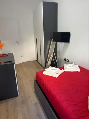 a bedroom with a red bed with a red blanket at Imera House City Retreat in Rome