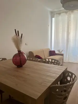 a living room with a wooden table with a vase on it at Imera House City Retreat in Rome