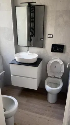 a bathroom with a sink and a toilet and a mirror at Imera House City Retreat in Rome