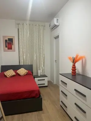 a bedroom with a red bed and a dresser at Imera House City Retreat in Rome