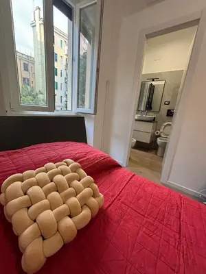 a bedroom with a red bed with a large window at Imera House City Retreat in Rome