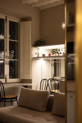 a living room with a couch and a kitchen at Monti Charme in Rome