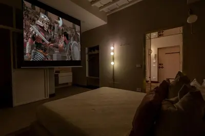 a bedroom with a bed and a flat screen tv at Monti Charme in Rome
