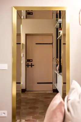 a door with a mirror in a room at Monti Charme in Rome