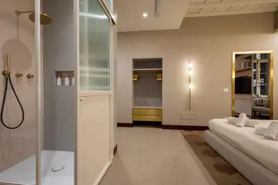 a bathroom with two beds and a shower at Monti Charme in Rome