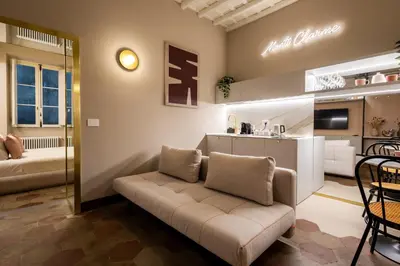 a living room with a couch and a kitchen at Monti Charme in Rome