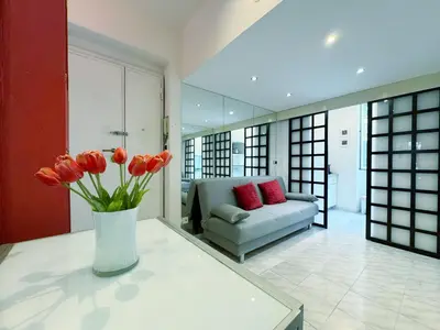 a living room with a vase of flowers on a table at San Pietro Apartment Vatican 5 min Walk in Rome