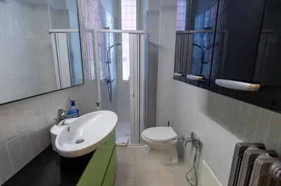 a bathroom with a sink and a toilet and a shower at San Pietro Apartment Vatican 5 min Walk in Rome