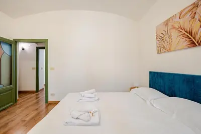 a bedroom with a bed with towels on it at Colosseo Comfort e Stile in centro a Roma in Rome