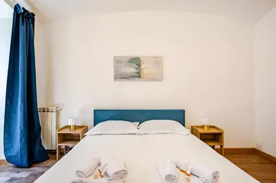 a bedroom with a bed with slippers on it at Colosseo Comfort e Stile in centro a Roma in Rome