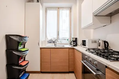 a kitchen with a sink and a stove top oven at Eleganza e charme a due passi da Piazza di Spagna in Rome
