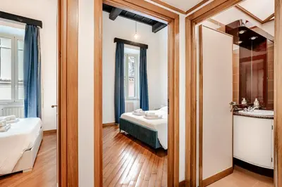 a bathroom with a bed and a sink in a room at Eleganza e charme a due passi da Piazza di Spagna in Rome