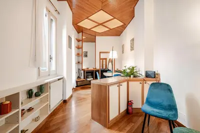 a room with a desk and a blue chair at Eleganza e charme a due passi da Piazza di Spagna in Rome
