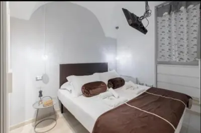 a bedroom with a bed with two bags on it at PIRAMIDE apartment in Rome