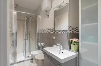 a bathroom with a sink and a toilet and a shower at PIRAMIDE apartment in Rome