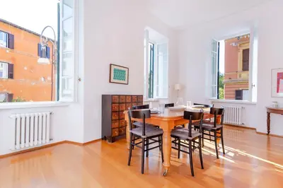 a dining room with a table and chairs at Elegantis Ten windows on Trastevere in Rome