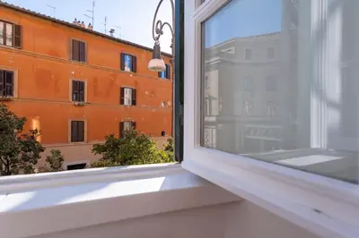 a window with a view of a building at Elegantis Ten windows on Trastevere in Rome