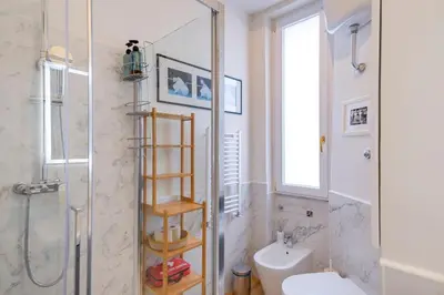 a bathroom with a shower and a toilet and a sink at Elegantis Gallo Suite Apartment - Few steps from the Vatican in Rome