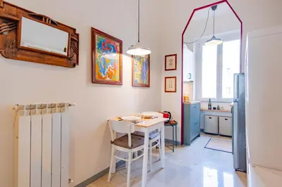 a kitchen with a table and chairs in a room at Elegantis Gallo Suite Apartment - Few steps from the Vatican in Rome