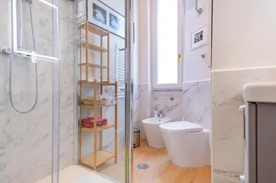 a bathroom with a shower and a toilet and a sink at Elegantis Gallo Suite Apartment - Few steps from the Vatican in Rome