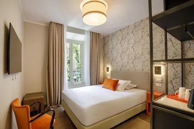 a hotel room with a bed and a window at Urban Garden Suites in Rome