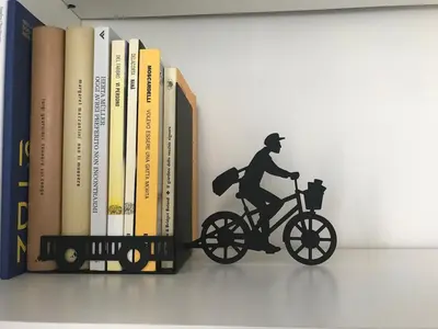 a figurine of a man riding a bike next to books at Panorama Home in Rome