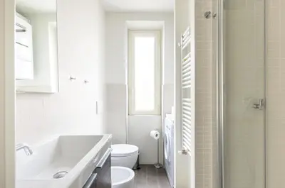 a white bathroom with a sink and a toilet at Panorama Home in Rome