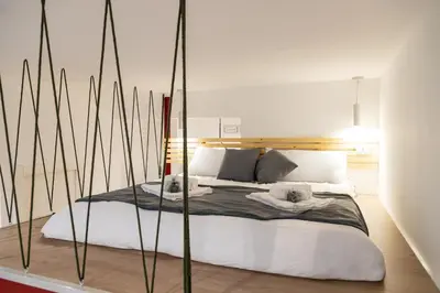 a bedroom with a bed with two dogs on it at Monolocale moderno a 2 min dalla metro B in Rome