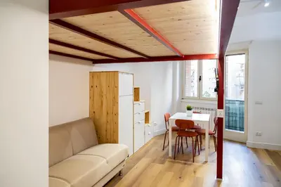a living room with a couch and a table at Monolocale moderno a 2 min dalla metro B in Rome