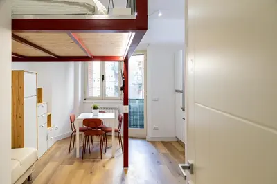 a room with a table and chairs and a bed at Monolocale moderno a 2 min dalla metro B in Rome