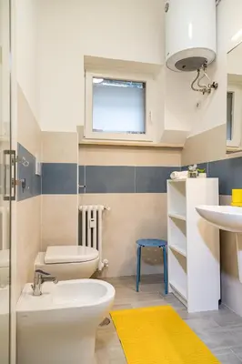 a bathroom with a toilet and a sink and a window at Moderno e centrale, a 2 min dalla metro B in Rome
