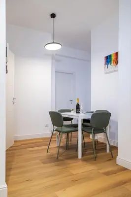 a dining room with a white table and chairs at Moderno e centrale, a 2 min dalla metro B in Rome