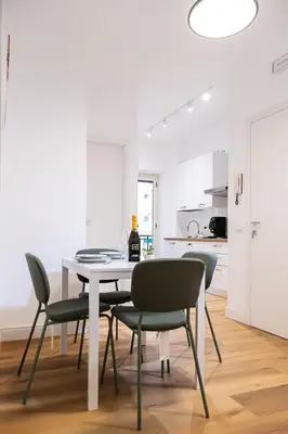 a white dining room with a table and chairs at Moderno e centrale, a 2 min dalla metro B in Rome