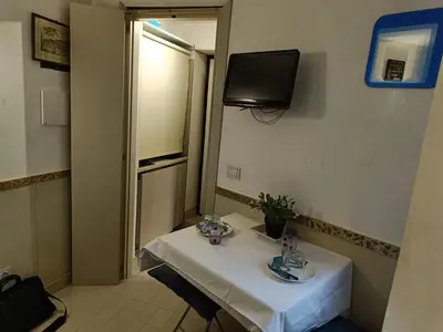 a small table in a room with a television on the wall at Domus Pantheon in Rome