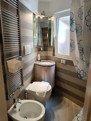 a small bathroom with a toilet and a sink at Domus Pantheon in Rome