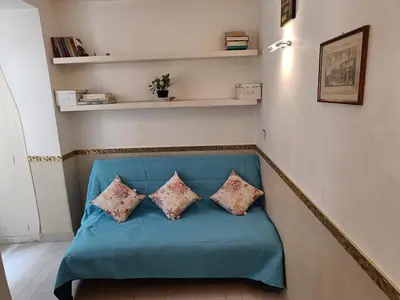 a blue couch with two pillows on it in a room at Domus Pantheon in Rome