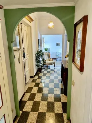 an arched hallway with a checkered floor in a house at Flaminio Charme in Rome