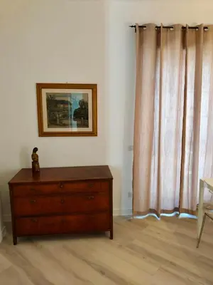 a bedroom with a dresser and a picture on the wall at Vatican Museum Home in Rome