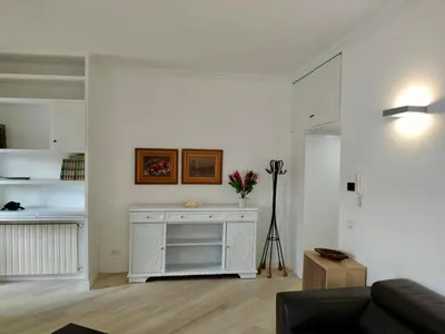 a white living room with a couch and a table at Vatican Museum Home in Rome