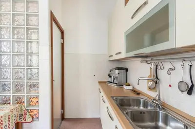 a small kitchen with a sink and a microwave at St John Home in Rome