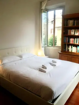 a bedroom with a large white bed with a window at St John Home in Rome
