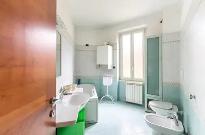 a bathroom with two sinks and two toilets at St John Home in Rome