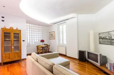 a living room with a couch and a tv at St John Home in Rome