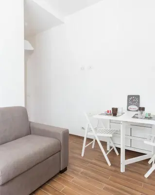 a living room with a couch and a white desk at Dream Forest in Rome