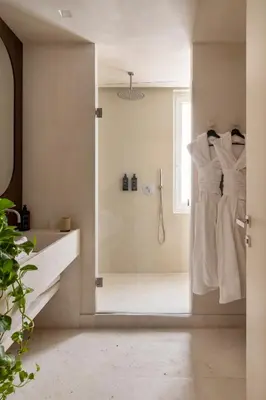 a bathroom with a shower with a glass door at NAMAN HOTELLERIE - Roma in Rome