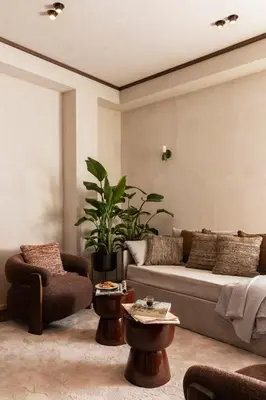 a living room with a couch and a potted plant at NAMAN HOTELLERIE - Roma in Rome