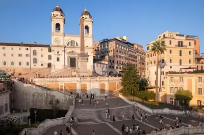 a group of people walking down stairs in front of a building at NAMAN HOTELLERIE - Roma in Rome